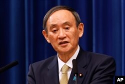 FILE - Japan's Prime Minister Yoshihide Suga speaks during a press conference at the prime minister's official residence in Tokyo, Jan. 13, 2021.
