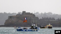 French fishing boats protest in front of the port of Saint Helier off the British island of Jersey to draw attention to what they see as unfair restrictions on their ability to fish in UK waters after Brexit, on May 6, 2021.