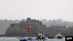 French fishing boats protest in front of the port of Saint Helier off the British island of Jersey to draw attention to what they see as unfair restrictions on their ability to fish in UK waters after Brexit, on May 6, 2021.