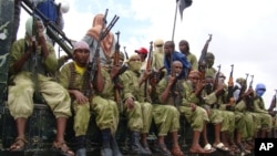 FILE - In this Oct. 30, 2009 file photo, al-Shabab fighters sit on a truck as they patrol in Mogadishu, Somalia.