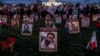 FILE - Protesters walk through a vigil honoring Iranians allegedly killed by their government during a rally in support of the ongoing protests in Iran at the National Mall, Dec. 17, 2022, in Washington. 