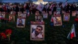 Protesters walk through a vigil honoring Iranians allegedly killed by their government during a rally in support of the ongoing protests in Iran at the National Mall, Dec. 17, 2022, in Washington.