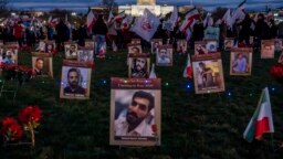 FILE - Protesters walk through a vigil honoring Iranians allegedly killed by their government during a rally in support of the ongoing protests in Iran at the National Mall, Dec. 17, 2022, in Washington. 