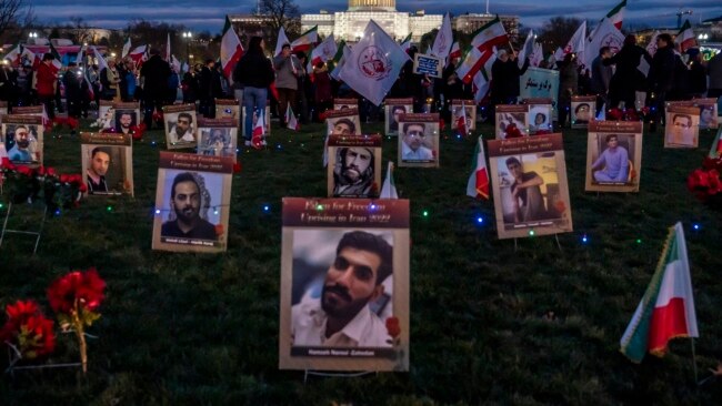 FILE - Protesters walk through a vigil honoring Iranians allegedly killed by their government during a rally in support of the ongoing protests in Iran at the National Mall, Dec. 17, 2022, in Washington.