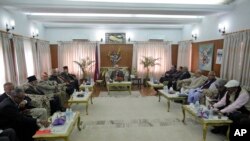 Nepal's prime minister Khadga Prasad Oli, centre, and top leaders sit during a meeting at prime minister's residence in Kathmandu, Nepal, Monday, Nov. 30, 2015.