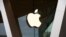 FILE - An Apple logo is seen on the facade of a downtown Brooklyn Apple store in New York, March 14, 2020. 