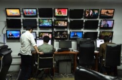 FILE - Afghan reporters of Tolo News work in the newsroom at Tolo TV station in Kabul, September 11, 2018.