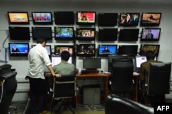 FILE - Afghan Tolo News reporters work in the newsroom of Tolo TV station in Kabul on September 11, 2018.