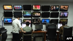 FILE - Afghan reporters work in the newsroom at Tolo TV in Kabul, Sept. 11, 2018.