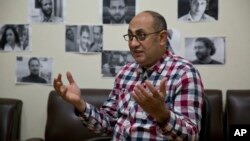 FILE - Activist lawyer Khaled Ali speaks to The Associated Press at his office in Cairo, Egypt, Feb. 6, 2017. 