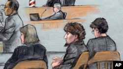 In this courtroom sketch, Assistant U.S. Attorney Aloke Chakravarty, left, is depicted addressing the jury as defendant Dzhokhar Tsarnaev, second from right, sits between his defense attorneys during closing arguments in Tsarnaev's federal death penalty t