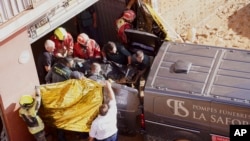 Members of the Spanish Guardia Civil move the body of a flood victim in Valencia, Spain, Oct. 31, 2024.