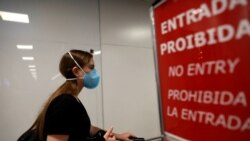 A traveler wears a face mask to protect against the coronavirus, at Salgado Filho Airport in Porto Alegre, Brazil, Feb. 27, 2020.