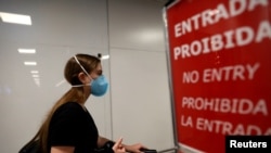 A traveler wears a face mask to protect against the coronavirus, at Salgado Filho Airport in Porto Alegre, Brazil, Feb. 27, 2020. 