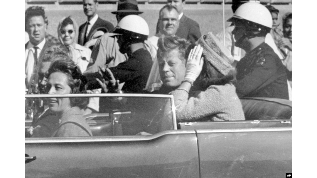 FILE - President John F. Kennedy waves from his car in a motorcade in Dallas, Texas, with first lady Jacqueline Kennedy, right, Nellie Connally, second from left, and her husband, Texas Gov. John Connally, far left, Nov. 22, 1963.