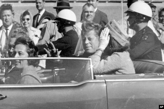 FILE - President John F. Kennedy waves from his car in a motorcade in Dallas, Texas, with first lady Jacqueline Kennedy, right, Nellie Connally, second from left, and her husband, Texas Gov. John Connally, far left, Nov. 22, 1963.