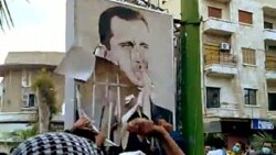 A video downloaded from YouTube shows Syrian anti-government protesters tearing down a portrait of President Basahr al-Assad in Hama on April 29, 2011 during the "Day of Rage" demonstrations