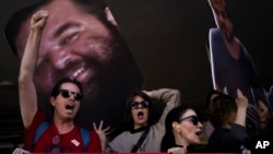 Demonstrators hold photos depicting the faces of Israeli hostages who are being held in the Gaza Strip, during a protest demanding their release from Hamas captivity, in Tel Aviv, Israel, March 6, 2025.