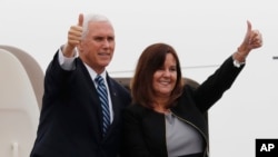 U.S. Vice President Mike Pence and his wife Karen give a thumbs-up as they board Air Force Two at the Yokota U.S. Air Force Base in Fussa, outside Tokyo, Japan, Nov. 13, 2018.