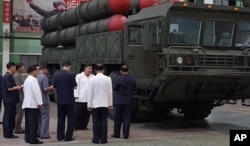 8일 국방공업기업소를 방문한 김정은 북한 국무위원장이 이동식발사대(TEL) 앞에서 관계자들과 대화하고 있다.