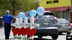 Four wooden crosses stand as a memorial for the four shooting fatalities outside a Waffle House restaurant, April 25, 2018, in Nashville, Tenn. The restaurant re-opened Wednesday after four people were killed by a gunman Sunday.