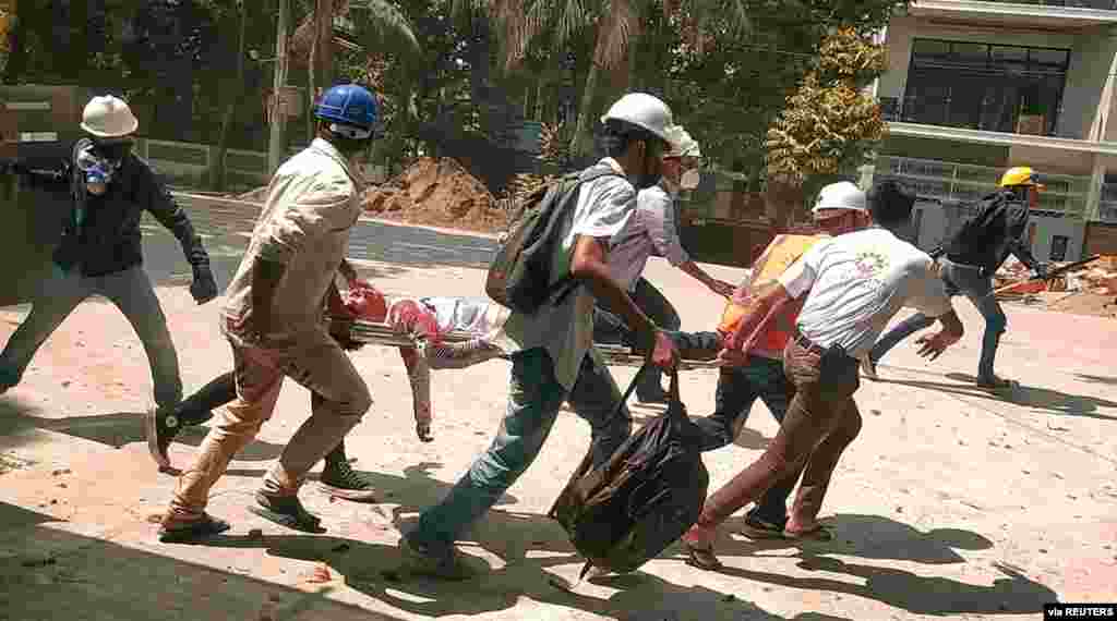 People carry Chit Min Thu on a stretcher during an anti-coup protest in North Dagon, Yangon, Myanmar, in this still image obtained by Reuters. The 25-year-old protester was shot in the head during a crackdown by security forces on the demonstrations.