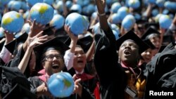 FILE - Graduates celebrate after receiving degrees from the John F. Kennedy School of Government during the 364th commencement exercises at Harvard University, Cambridge, Massachusetts, May 28, 2015.