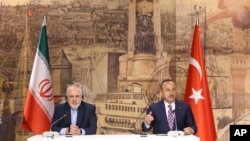 Turkish Foreign Minister Mevlut Cavusoglu, right, and Iran's Foreign Minister Mohammad Javad Zarif, speak to the media after their talks, in Istanbul, June 15, 2020