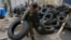 An armed man carry tires to form barricades in front of the police headquarters in Slaviansk April 12, 2014. 