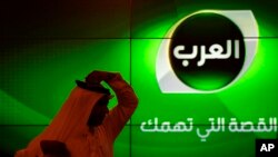 FILE - A man adjusts his headscarf during a press conference for the launch of now shuttered Alarab news channel in Manama, Bahrain.