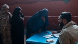 A woman registers to receive money from the WFP in Kabul on Nov. 17, 2021. (AP/Petros Giannakouris)