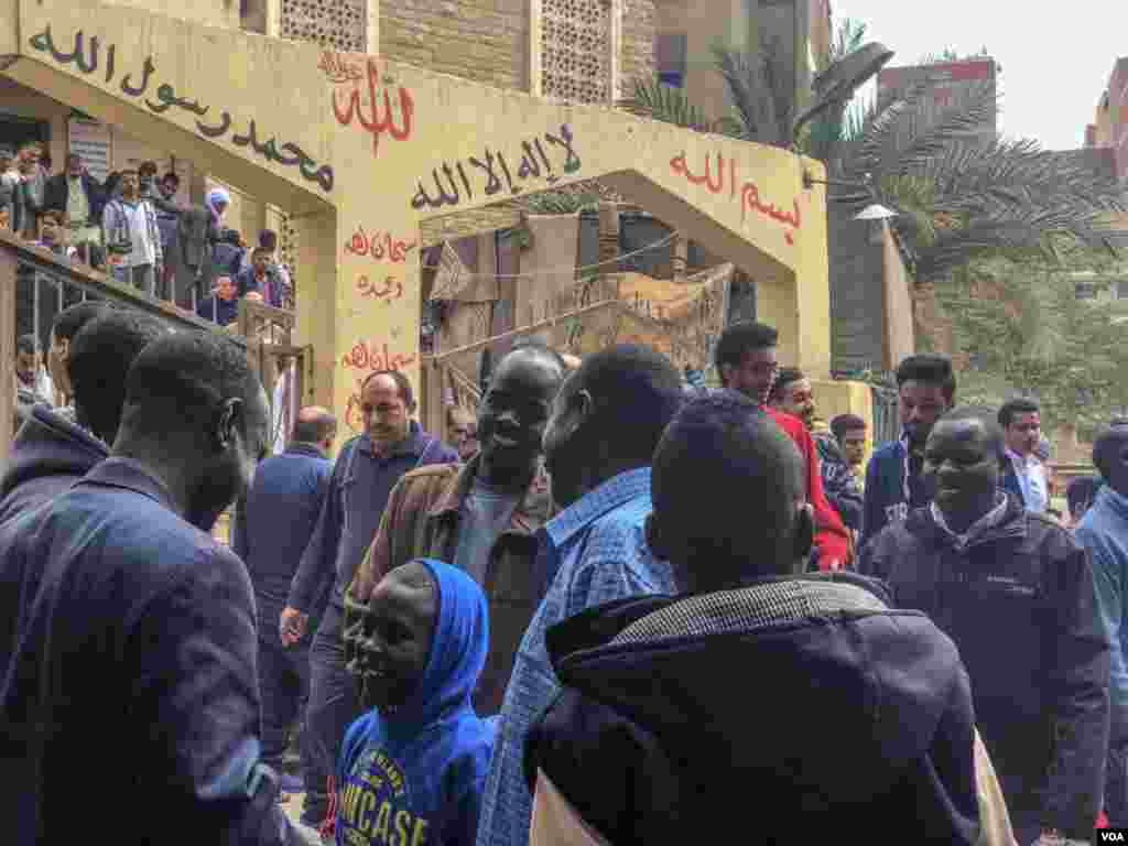 Sudanese refugees greet each other after Friday prayers in El-Barajil, a village on the outskirts of greater Cairo. (H. Elrasam/VOA)