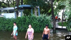 People Wade in Flooded Northwest Bangkok Neighborhood