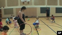 Catherine Byrne and her daughter Bridget, 3, attend a mobile gym class at an elementary school gymnasium in the Washington suburbs.