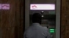 FILE - A customer is seen inside an Equity ATM lobby in downtown Nairobi, Kenya, May 16, 2023.