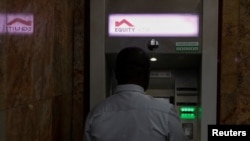 FILE - A customer is seen inside an Equity ATM lobby in downtown Nairobi, Kenya, May 16, 2023.