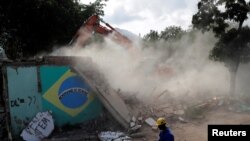 The house of Carlos Augusto and Sandra Regina (not pictured) who have lived in Vila Autodromo slum for 20 years with their children, is demolished after the family moved to one of the twenty houses built for the residents who refused to leave the community, in Rio de Janeiro, Brazil, August 2, 2016. Picture taken August 2, 2016. 