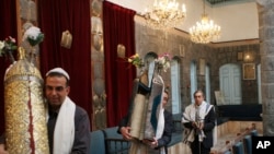 FILE - Syrian Jews celebrate Passover at the al-Firenj Synagogue in downtown Damascus, Syria, April 20, 2008. Artifacts removed from one of the oldest synagogues in the world in the Syrian capital have gone missing after neighborhood officials said they gave them to commanders of a rebel group who never gave them back.