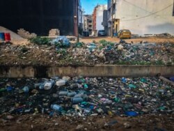 Hordes of trash sully a canal near a beach in Dakar. (A. Hammerschlag/VOA)