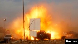 Explosion seen during car bomb attack at Shi'ite political organization's rally in Baghdad, April 25, 2014.