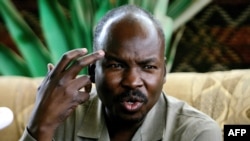 FILE - Ahmed Harun, then-governor of South Kordofan, a Sudanese province, gestures during a press conference in Talodi, South Kordofan, April 12, 2012. 