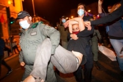 Israeli police drag a protester as they forcibly clear the square outside Prime Minister Benjamin Netanyahu's residence in Jerusalem, Oct. 17, 2020.