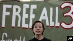 Sarah Shourd asks for the release of her jailed fiance and friend in front of sign that reads "Free All 3" at a vigil in Oakland, California last month