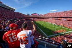 FILE - Kansas City Chiefs fans do the "tomahawk chop" before the start of an NFL football game against the Buffalo Bills on Oct. 16, 2022, in Kansas City, Missouri.