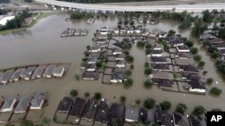 Homes are surrounded by floodwaters from Tropical Storm Harvey, Aug. 29, 2017, in Spring, Texas. 