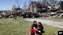 Nathaniel Ramey, left, comforts Megan Hurst at her grandmother's house in Askewville, North Carolina., Sunday, April 17, 2011 after a tornado struck Saturday