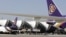 FILE - Thai Airways passenger planes park at the ramp of Bangkok's Suvarnabhumi airport.