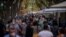 People wearing face masks walk along a boulevard in Barcelona, Spain on Aug. 30, 2020. 