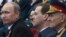 Russian President Putin and Prime Minister Medvedev, center, watch Victory Day Parade, Moscow, May 9, 2012.
