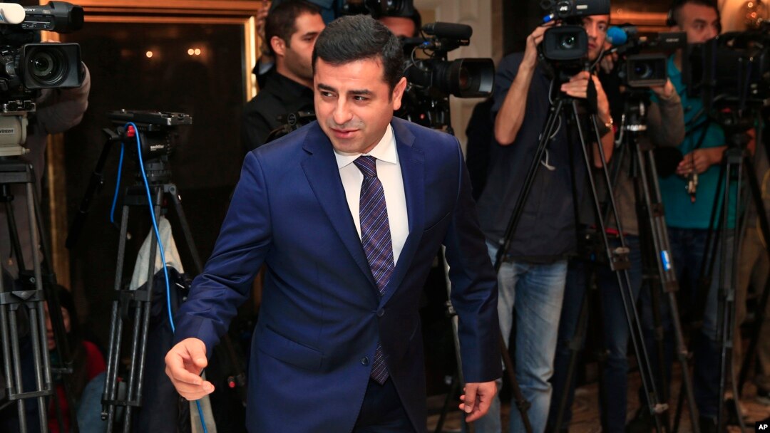FILE - Selahattin Demirtas, co-leader of the pro-Kurdish Peace and Democracy Party, arrives for a meeting with representatives of minorities living in Turkey at a hotel in central Istanbul ahead of elections, Oct. 28, 2015.